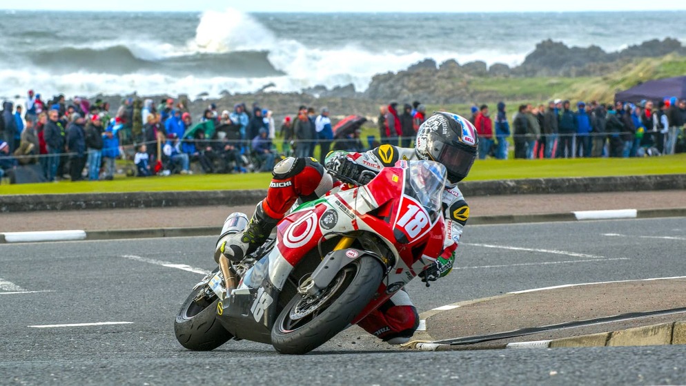 Motorcyclist leaning into a corner during the North West 200 road race on the Causeway Coast, Northern Ireland.