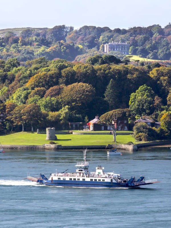 Traditional fishing boats in Portaferry Harbour with Strangford Lough and Mourne Mountains in the background.
