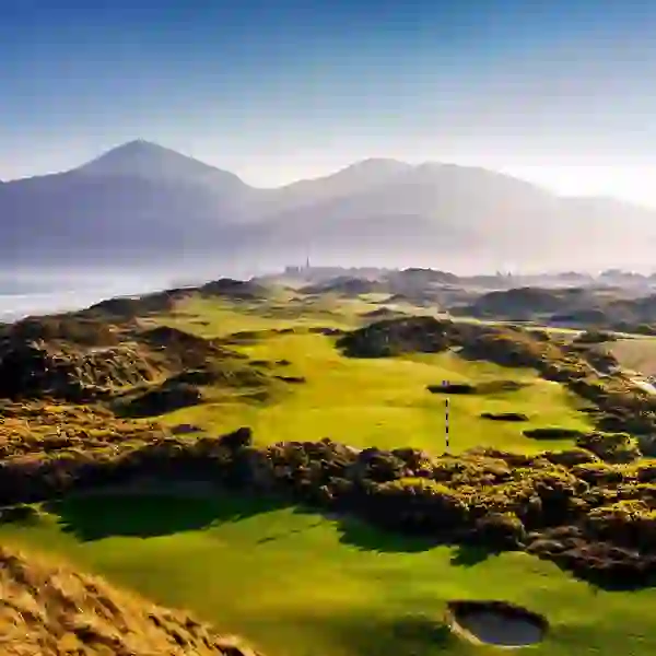 Royal County Down Golf Club in Newcastle, County Down, with fairways set against the Mourne Mountains and coastal views.
