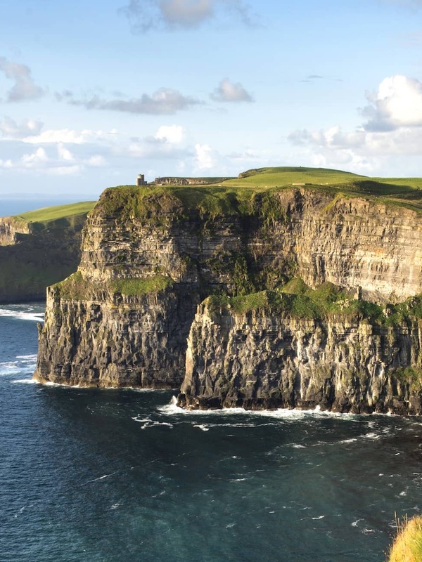 Sheer sea cliffs and crashing Atlantic waves at the iconic Cliffs of Moher in County Clare, Ireland.