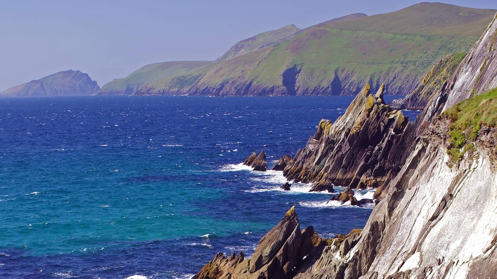 Rocky cliffs meet crashing waves and deep blue Atlantic on the wild coastline of the Ring of Kerry.