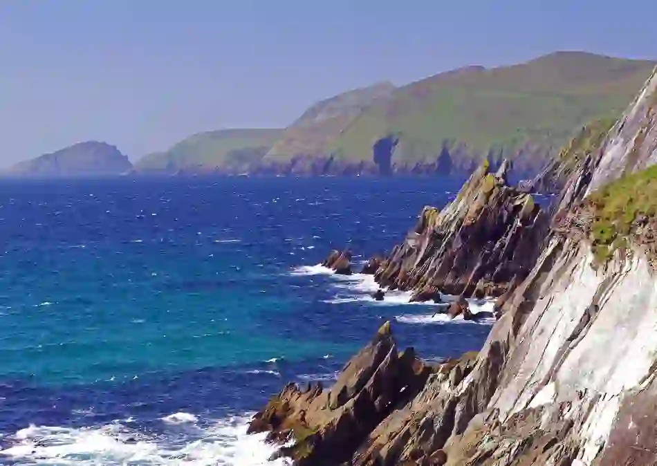 Rocky cliffs meet crashing waves and deep blue Atlantic on the wild coastline of the Ring of Kerry.