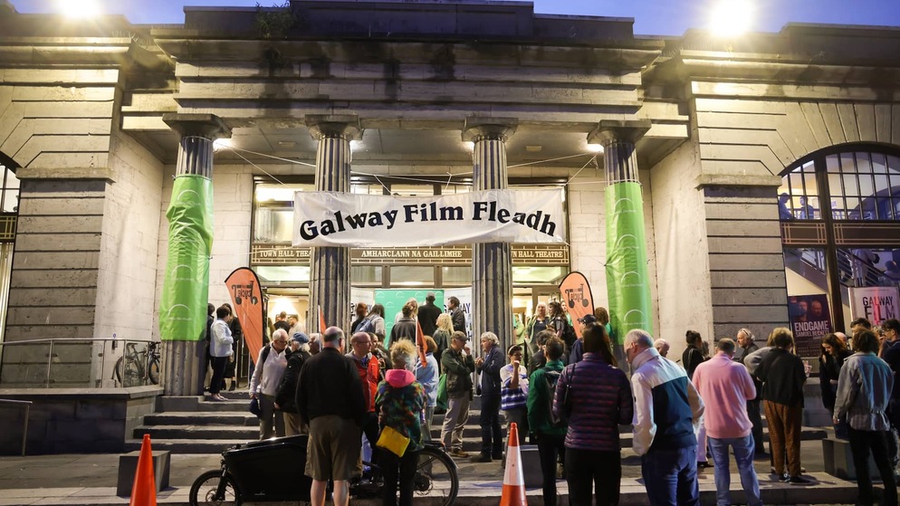 Evening crowd gathered outside the entrance of Galway Town Hall Theatre beneath a banner for the Galway Film Fleadh.