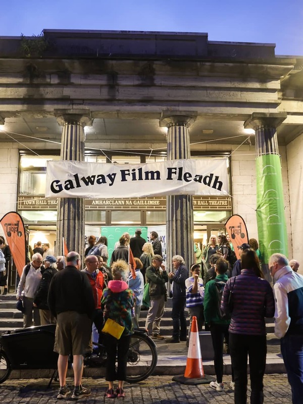 Evening crowd gathered outside the entrance of Galway Town Hall Theatre beneath a banner for the Galway Film Fleadh.