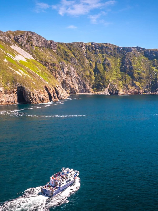Tour boat cruises below the towering Slieve League cliffs on the Wild Atlantic Way in County Donegal.