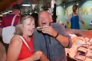 A couple smiling while eating oysters