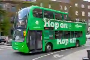 A green hop on hop off bus