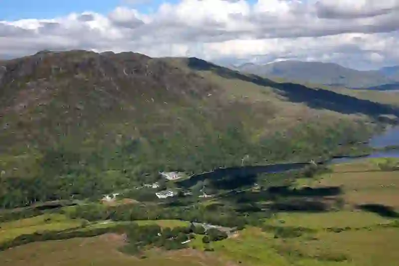 Aerial view of Kylemore Abbey nestled by a lake amid the Connemara mountains in County Galway.