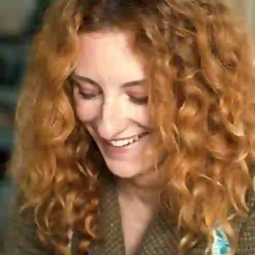 Close-up portrait of a smiling red-haired woman in County Kerry.