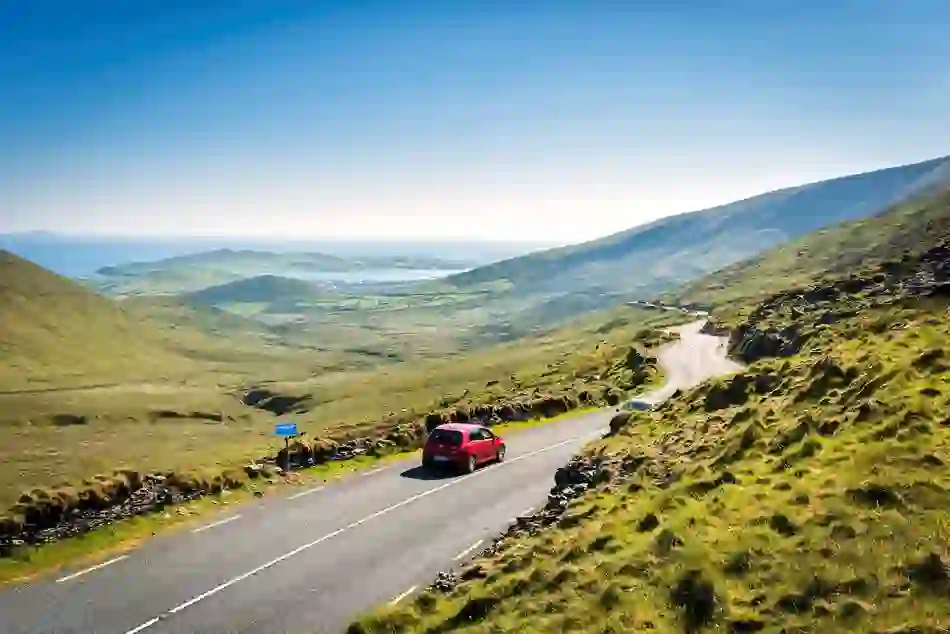 Scenic drive through Conor Pass overlooking mountains and the Atlantic coast in County Kerry.