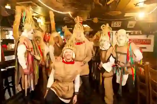 Roman Kemp posing with traditional mummers in a Dublin pub during the Irish road trip.