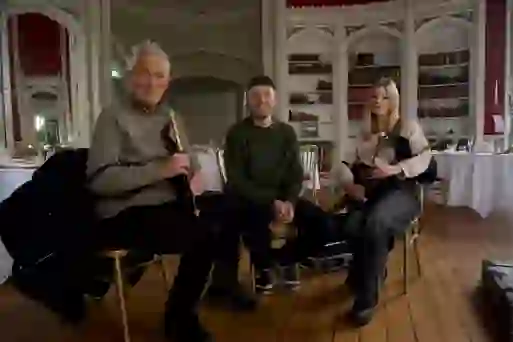 Martin and Roman Kemp with a young uilleann piper in a grand Irish country house.