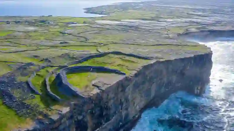 Dún Aonghasa sits dramatically on sea cliffs above the Atlantic on the Aran Islands, County Galway.