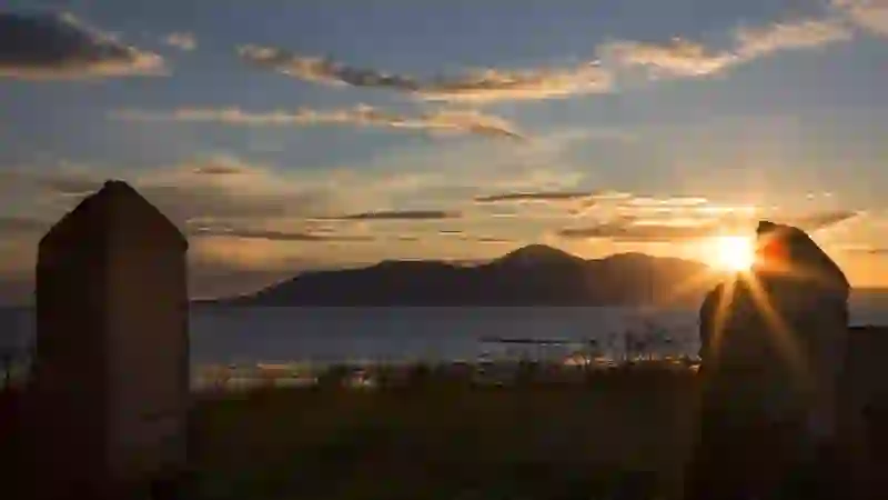 Sunset over Rossglass Beach near Killough with Mourne Mountains silhouetted across Dundrum Bay, County Down.