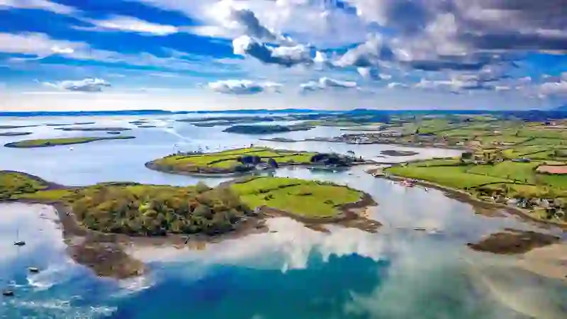 Aerial view of Strangford Lough’s islands, inlets and patchwork fields under a bright sky, County Down.