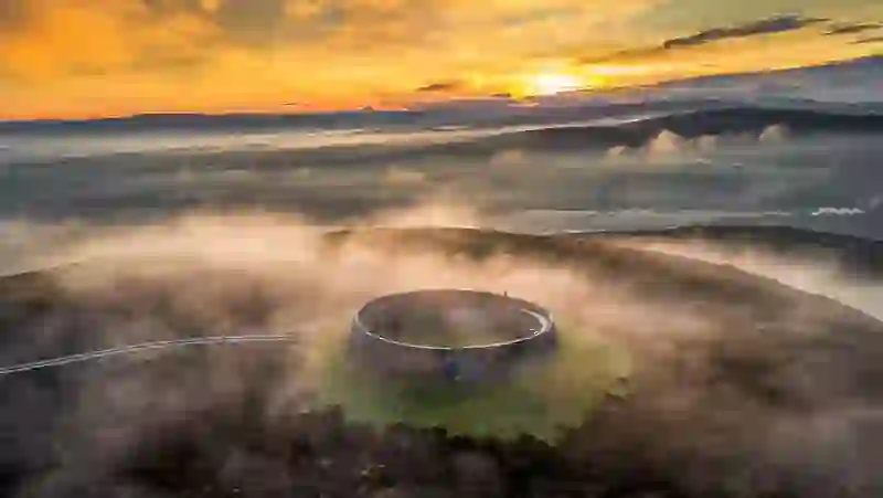 Aerial view of Grianan of Aileach stone ringfort surrounded by mist at sunrise, County Donegal.