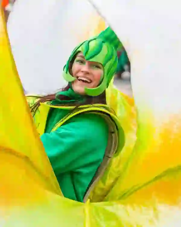 Person in bright green costume celebrating St Patrick’s Day at a festival in Limerick city.
