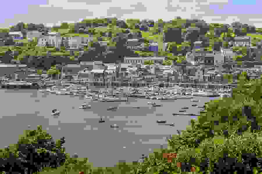 Yacht ormeggiati nel colorato porto di Kinsale con rigogliose colline verdi sullo sfondo, nella contea di Cork