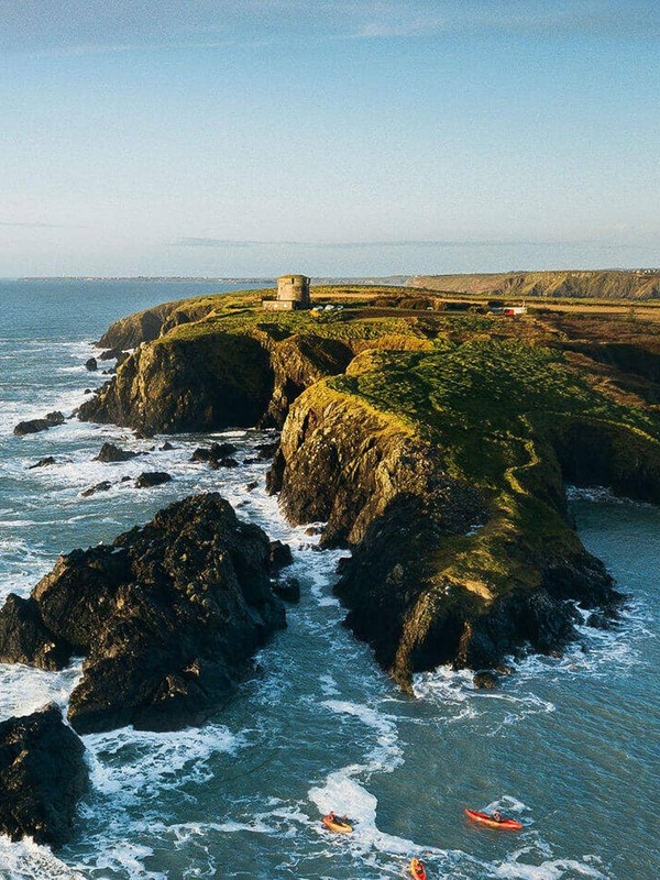 Rugged cliffs on the Wexford coast with a Martello tower overlooking the Atlantic Ocean.