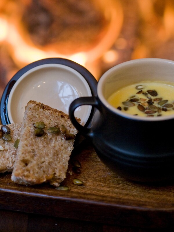 Bowl of soup with soda bread topped with seeds served by the fire at Grace Neill’s pub in Donaghadee, County Down.
