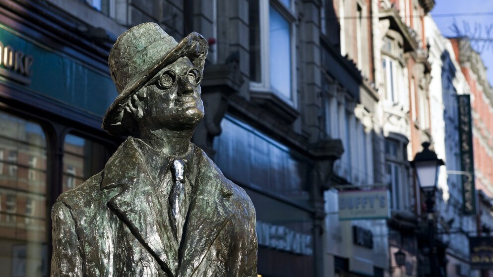 Bronze statue of James Joyce in Dublin city centre, captured against a backdrop of historic Georgian buildings.