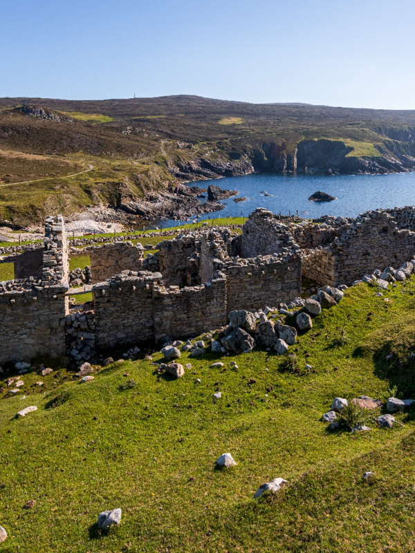 Ruins of An Port village overlooking a rocky bay at Glencolmcille in County Donegal.