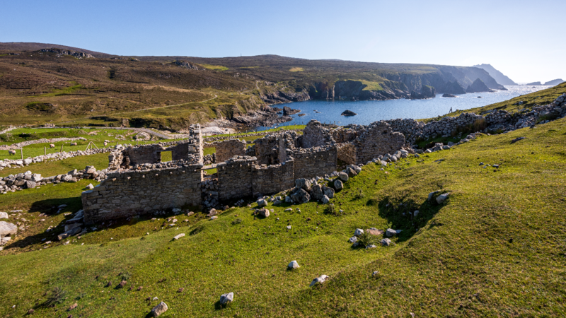 Ruins of An Port village overlooking a rocky bay at Glencolmcille in County Donegal.