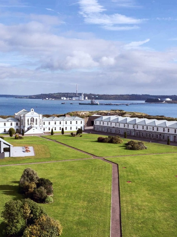 View over Spike Island’s historic prison buildings with Cork Harbour and Cobh in the background.
