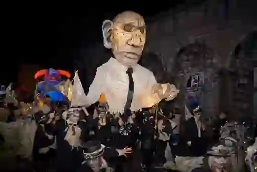 Street performers and parade floats go by at the Samhain Festival in Limerick city.