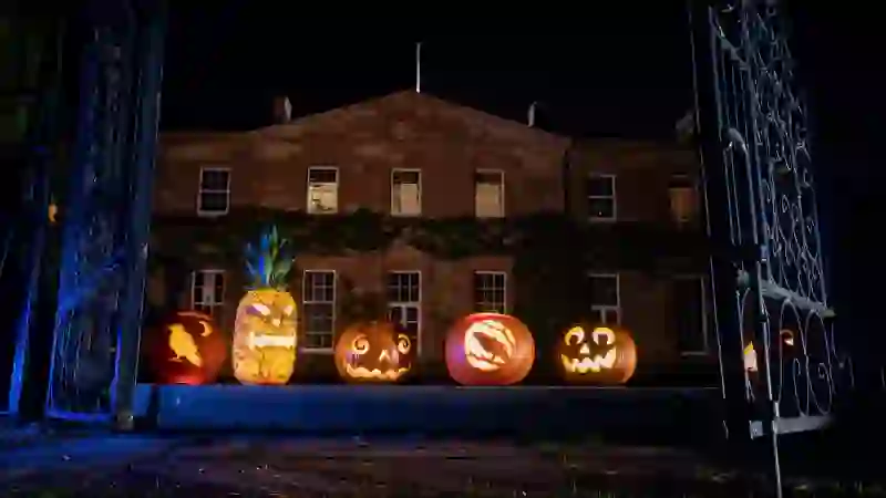 Carved Halloween pumpkins outside Hillsborough Castle at night in Royal Hillsborough, County Down.