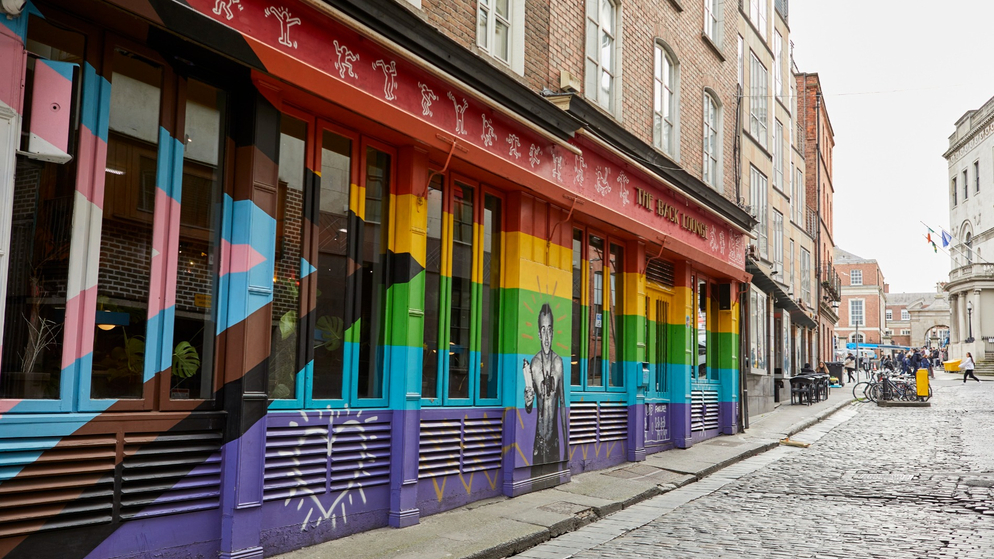 The Back Lounge pub in Dublin painted with rainbow and trans Pride colours on its exterior.