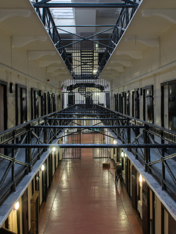 Victorian prison cell blocks and iron walkways inside Crumlin Road Gaol in Belfast.
