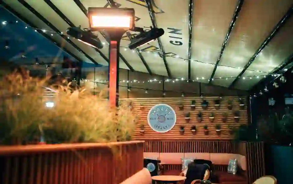 Tetto rooftop bar in Belfast, with covered seating, string lights and a Malfy Gin display.