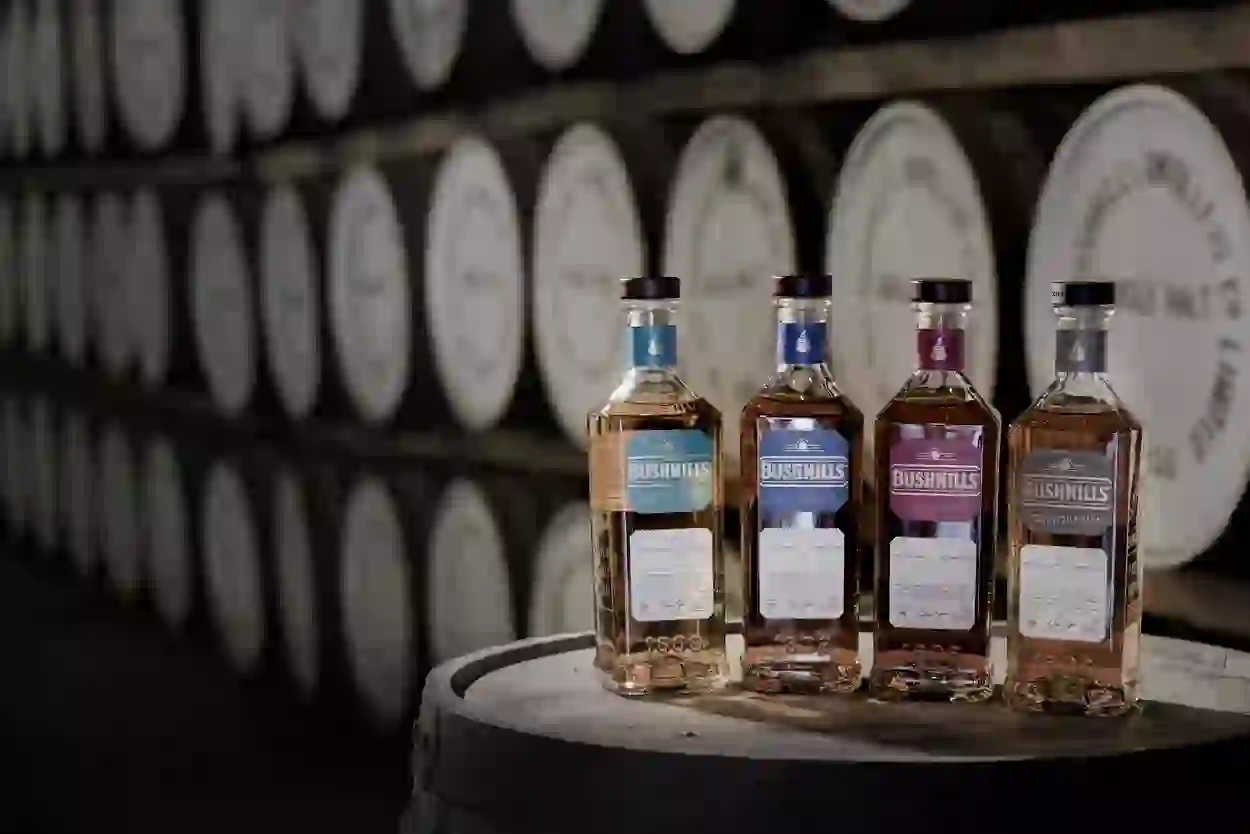 Bushmills whiskey bottles displayed on a barrel inside Bushmills Distillery, County Antrim.