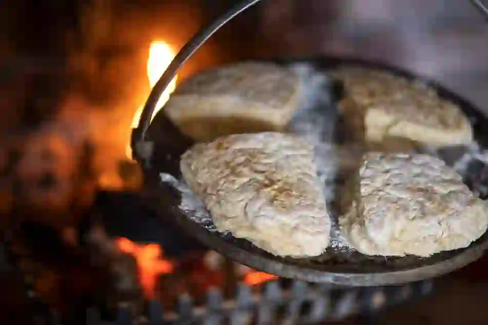 Traditional Northern Irish soda farls cooking on a griddle over an open fire