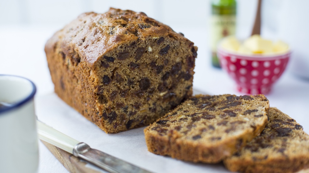 A traditional Irish barmbrack fruit loaf, sliced and ready to serve with butter.