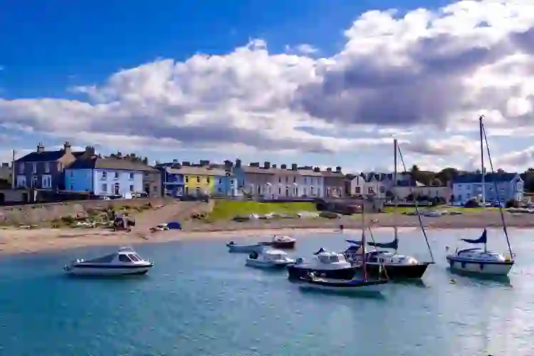 Boats in Greystones Harbour beside the colourful seafront in County Wicklow, Ireland.