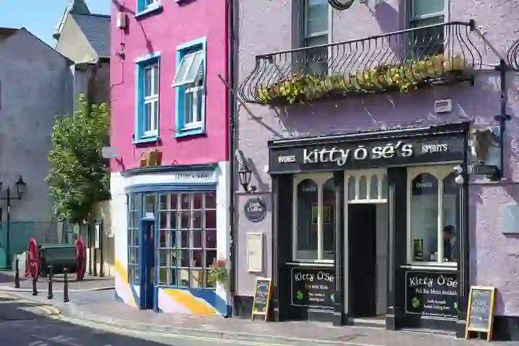 Colourful shopfronts on a street in Kinsale, County Cork, including Kitty O’Sé’s pub.