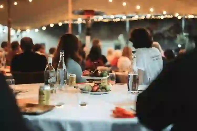 Guests seated at a table with apples and drinks during the Armagh Food and Cider Weekend.