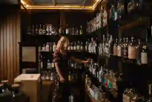 Woman browsing bottles in the Gin Library at Galgorm Resort and Spa, Ballymena, County Antrim.