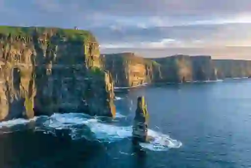 Dramatic Cliffs of Moher on Ireland’s Wild Atlantic Way, with waves crashing below the towering sea cliffs.