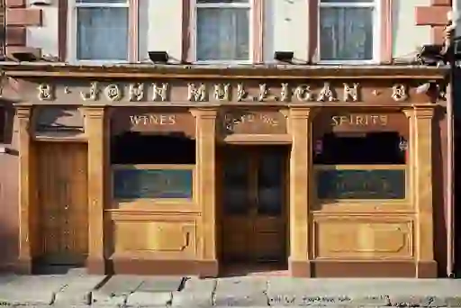 Mulligan's pub frontage in Dublin with carved wooden panels and “Spirits” and “Wines” signage.