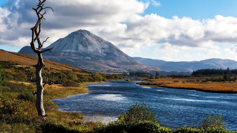 A river winds through moorland beneath Errigal, a dramatic conical mountain in County Donegal.