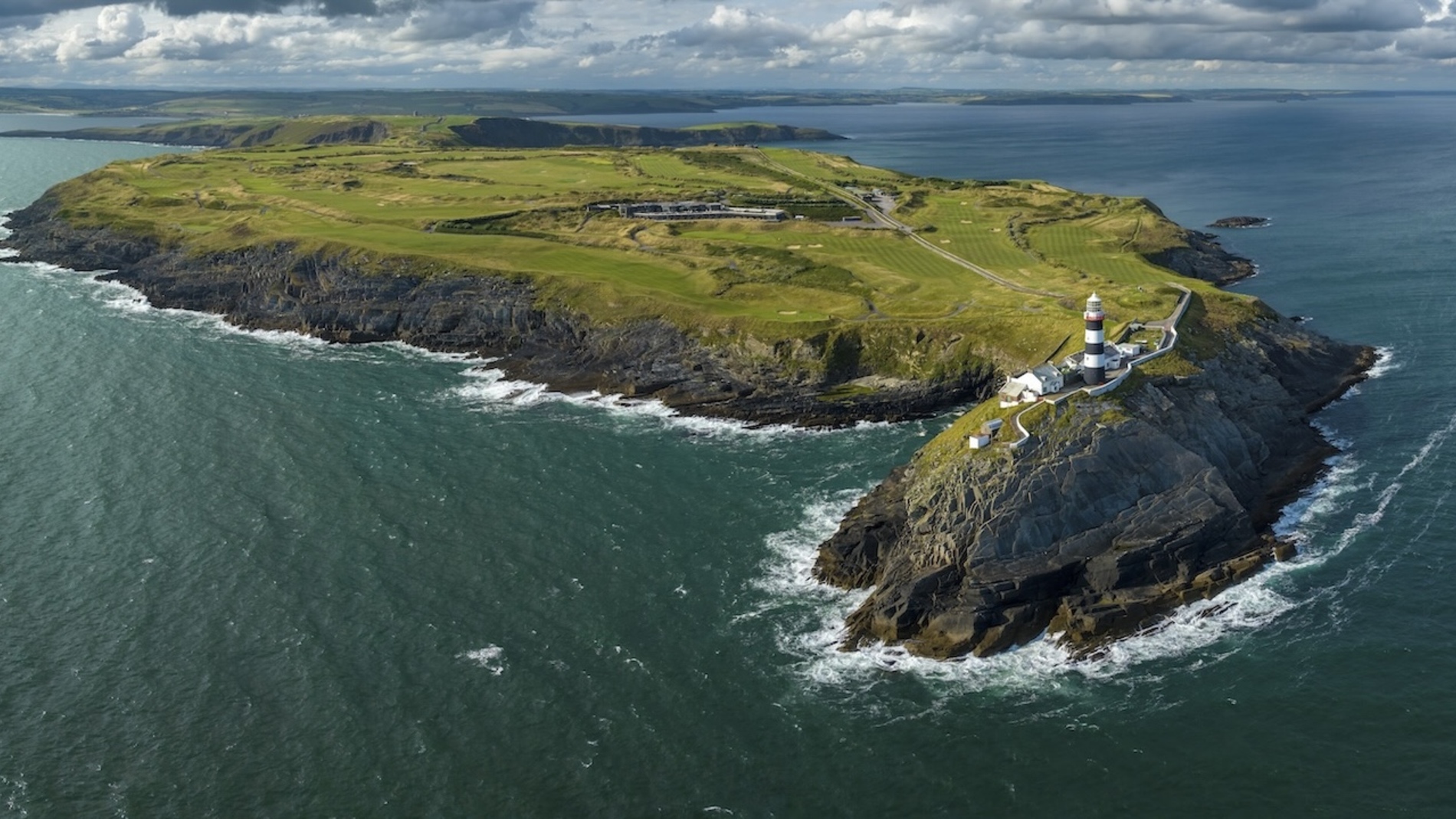 Aerial view of the Old Head of Kinsale lighthouse and cliffs, County Cork.