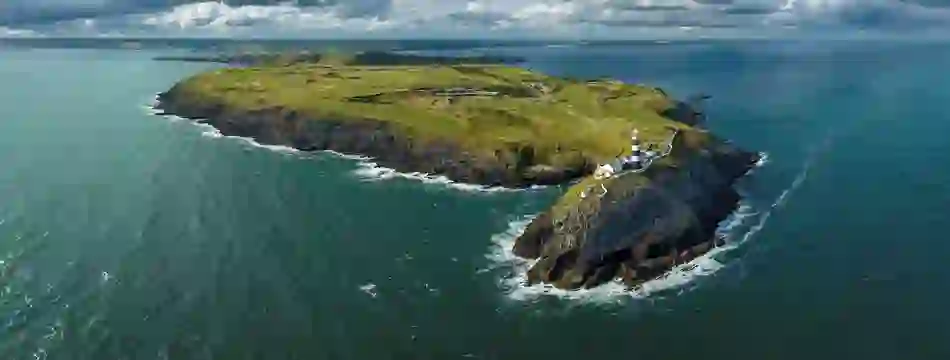 Aerial view of the Old Head of Kinsale lighthouse and cliffs, County Cork.