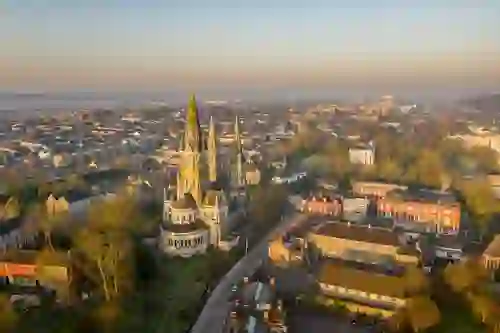 Aerial view of St Fin Barre’s Cathedral and Cork city at sunset.