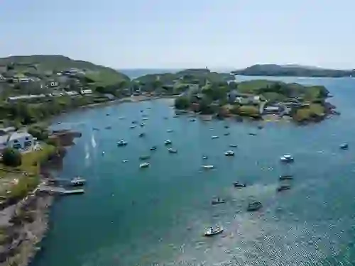 Aerial view of Baltimore harbour in West Cork with fishing boats anchored in the bay.
