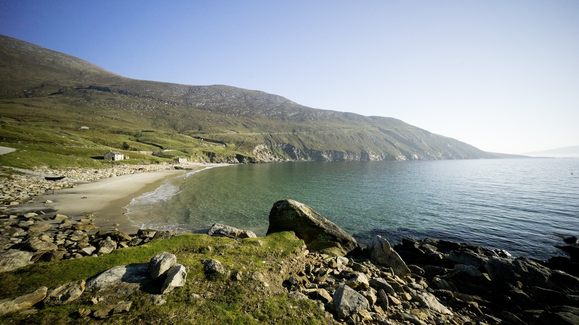 Keem Strand curving around a sheltered bay beneath rugged hills on Achill Island, County Mayo.