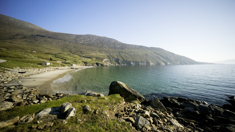 Keem Strand curving around a sheltered bay beneath rugged hills on Achill Island, County Mayo.