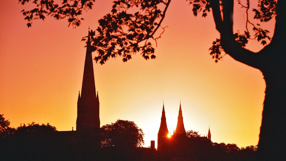 Silhouette of cathedral spires at sunset in Armagh, Northern Ireland.